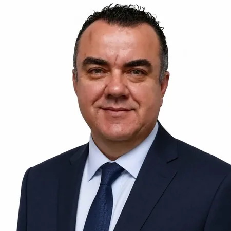 Stuart Newman | Australian Higher Education Group A business professional, Stuart Newman, smiles for a portrait on the AHEG website.