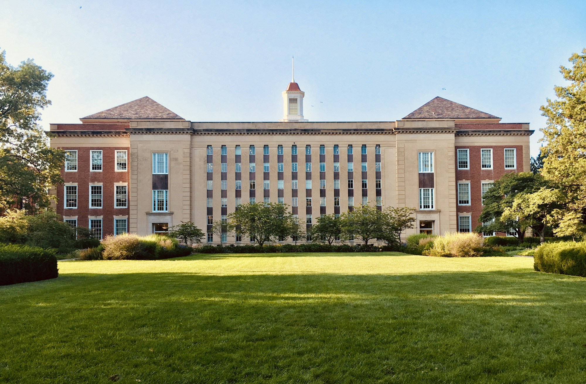 University Campus | Australian Higher Education Group A university building with classic brick architecture and a manicured lawn represents higher education.